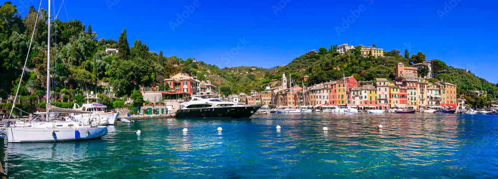 Portofino  -Luxury resort and beautiful colorful village in Liguria. Panoramic view with colorful houses and sail boats. Italy travel