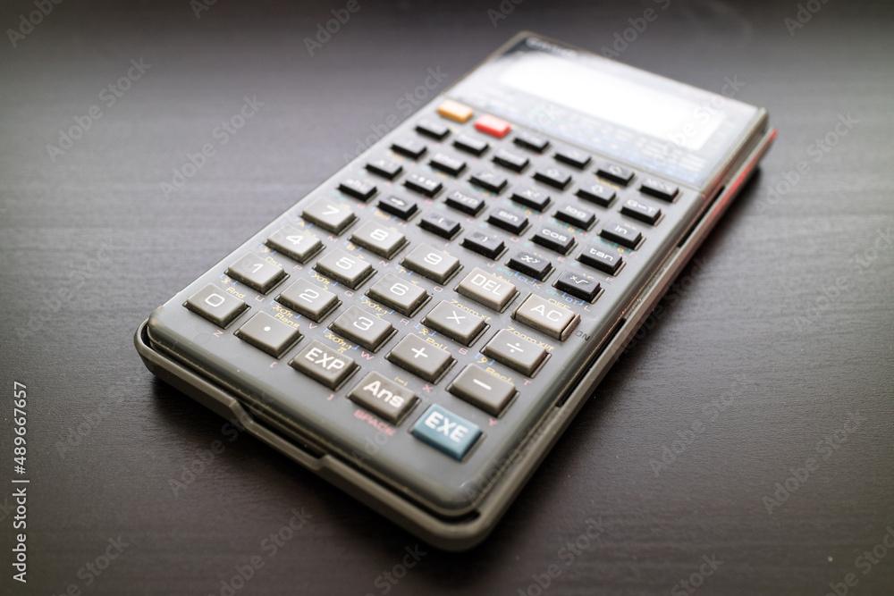 Scientific calculator on black surface background Scientific calculator on black surface background