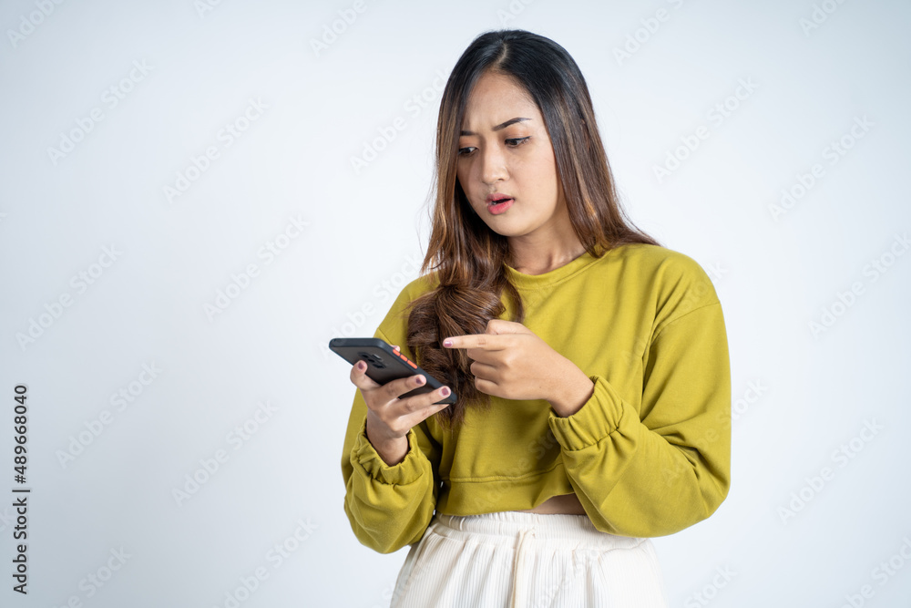young woman confused when they look at the mobile screen young woman confused when they look at the mobile screen