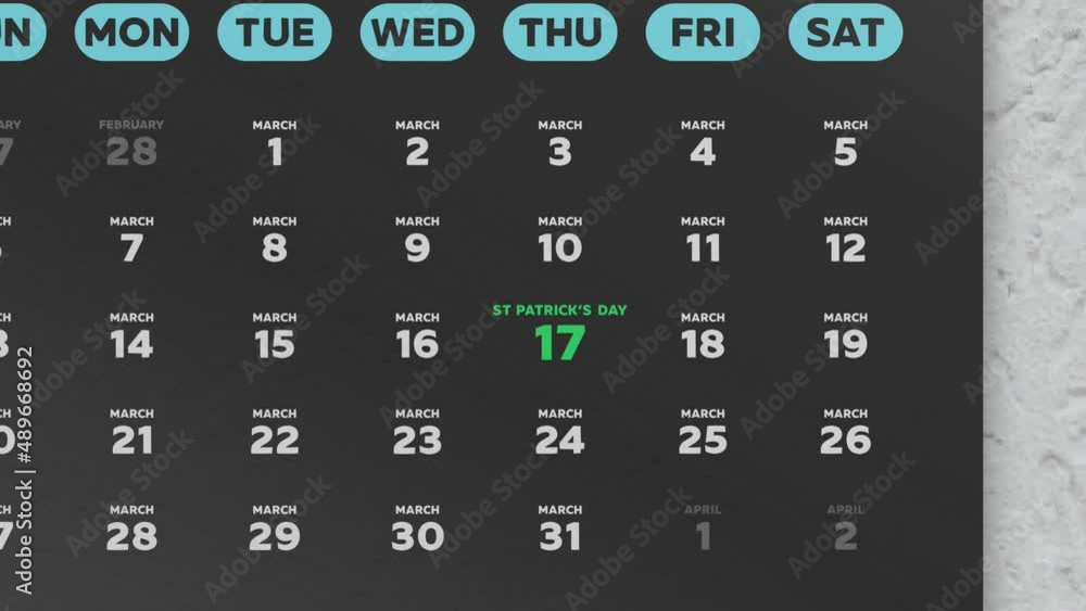 Close-up of a black beautiful March page of the wall calendar 2022 and the camera moves to Saint Patrick's Day date Close-up of a black beautiful March page of the wall calendar 2022 and the camera moves to Saint Patrick's Day date