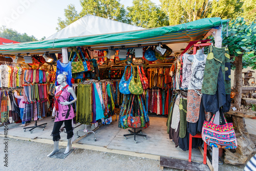 Display of colorful clothing on a street market © Serjedi