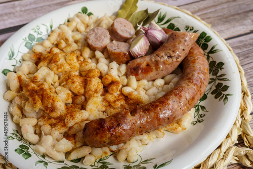 butifarra with beans, Botifarra amb mongetes or Botifarra amb seques, is a traditional dish of Catalan cuisine, based on butifarra and white beans. photo