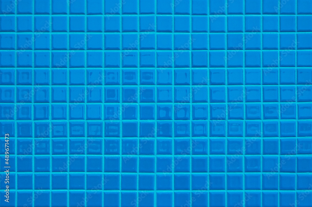 Blue ceramic wall and floor tiles mosaic abstract background. Design geometric wallpaper texture decoration. Blue ceramic wall and floor tiles mosaic abstract background. Design geometric wallpaper texture decoration.