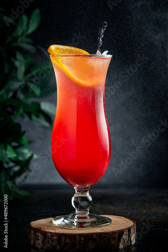 Fresh citrus tropical Mai tai cocktail on a dark background. Alcoholic Long drink cocktail with rum and orange