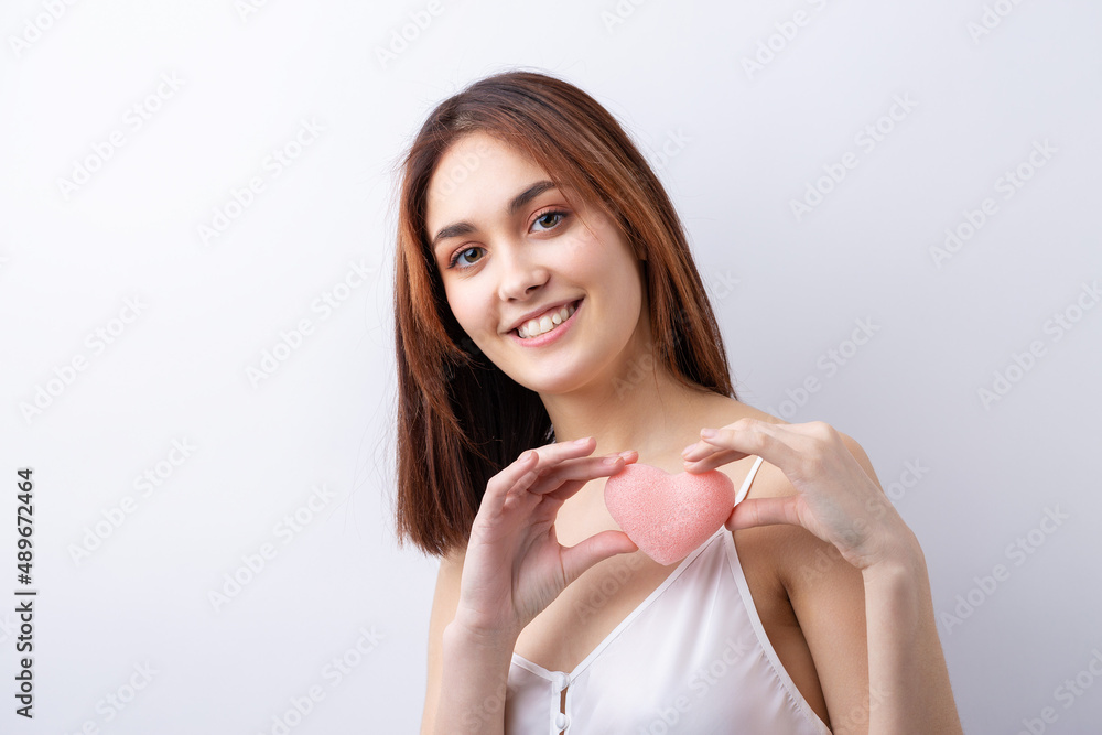 Beautiful smiling woman with clean skin, natural make-up and white teeth on a gray background Beautiful smiling woman with clean skin, natural make-up and white teeth on a gray background