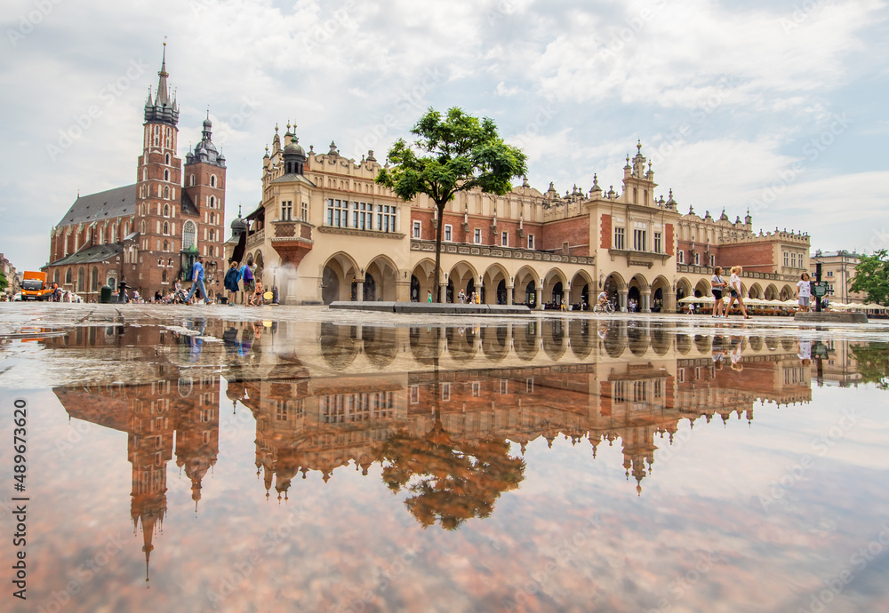 Krakow, Poland - frequent rainshowers make Old Town Krakow look like a mirror when it's full wet. Here in particular Market Square, a main landmark 
