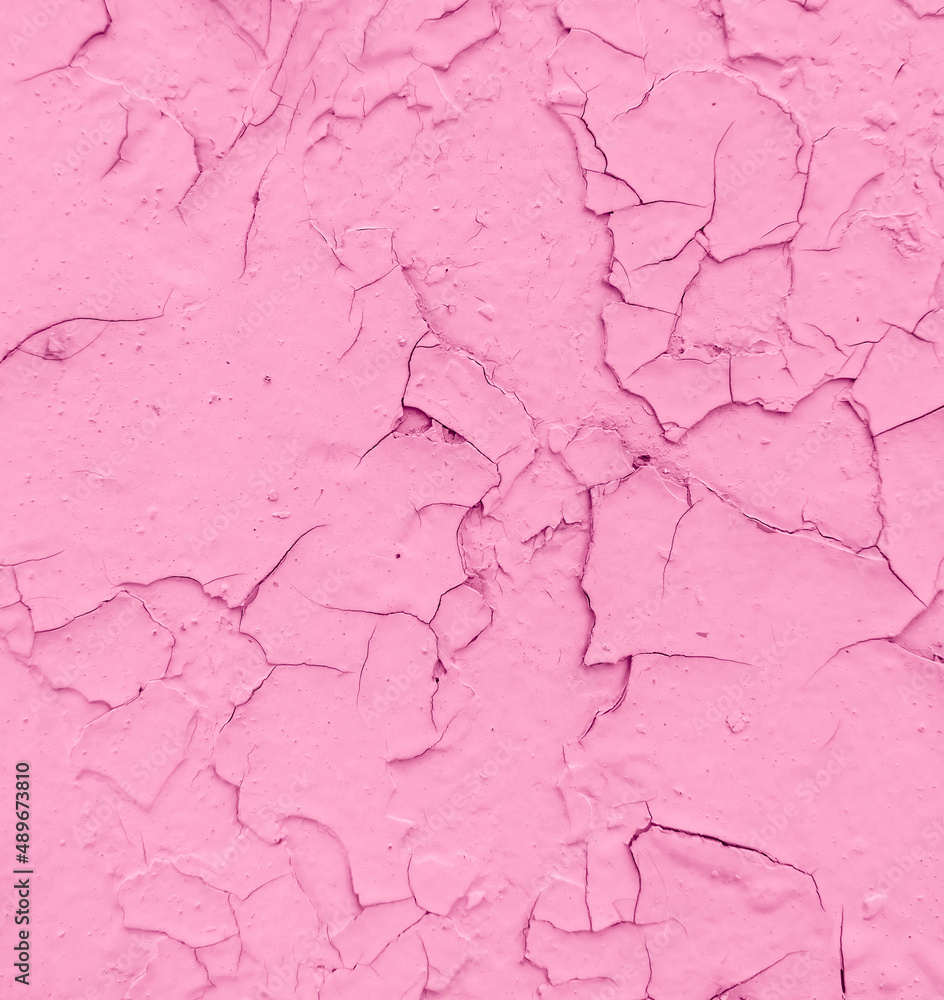 Cracked pink paint on the wall as an abstract background.