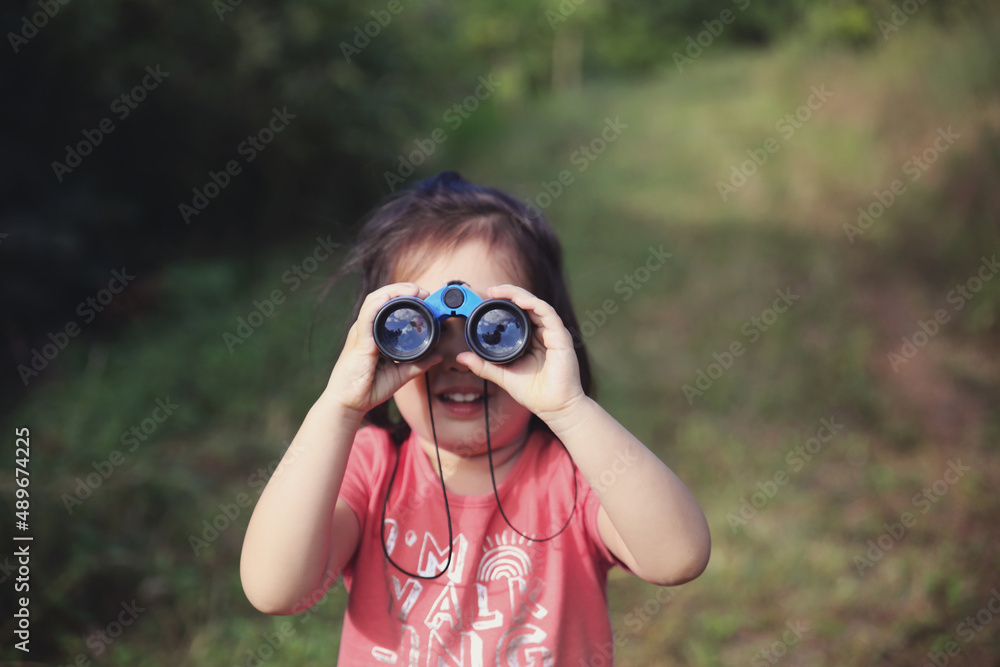 Little girl using binoculars Little girl using binoculars