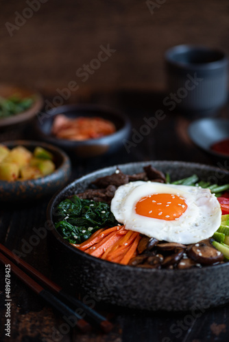  Bibimbap on a wooden background, traditional korean dish