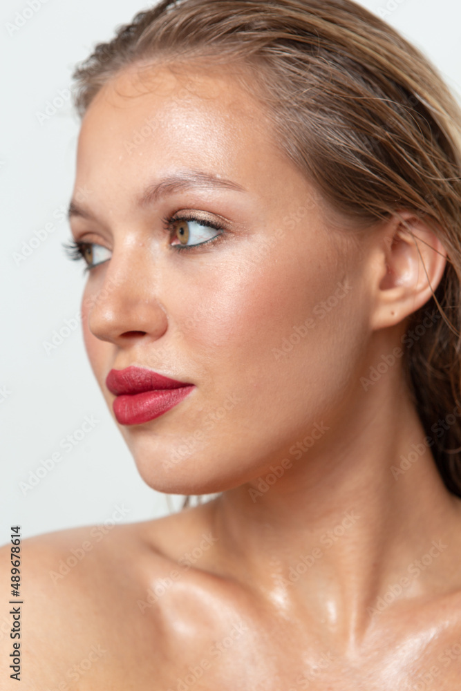 Portraits of a pretty girl with makeup and hair on a white background 