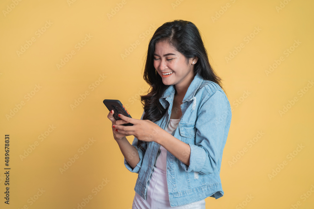 Young asian woman using mobile cell phone typing sms message Young asian woman using mobile cell phone typing sms message