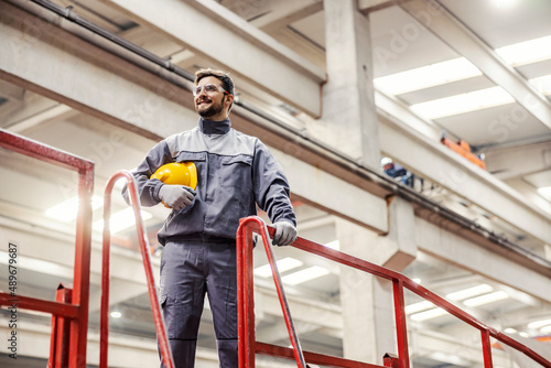 A heavy industry worker standing on his workplace and gazing.