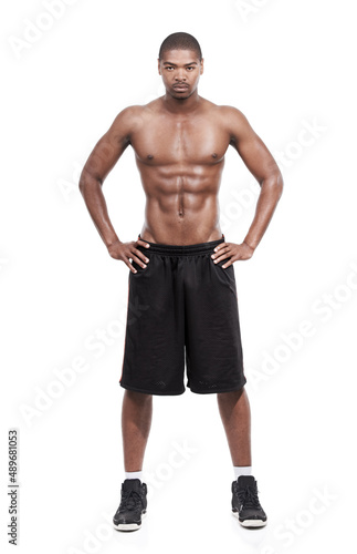 Confident in his masculinity. Portrait of a handsome young man standing shirtless in the studio.