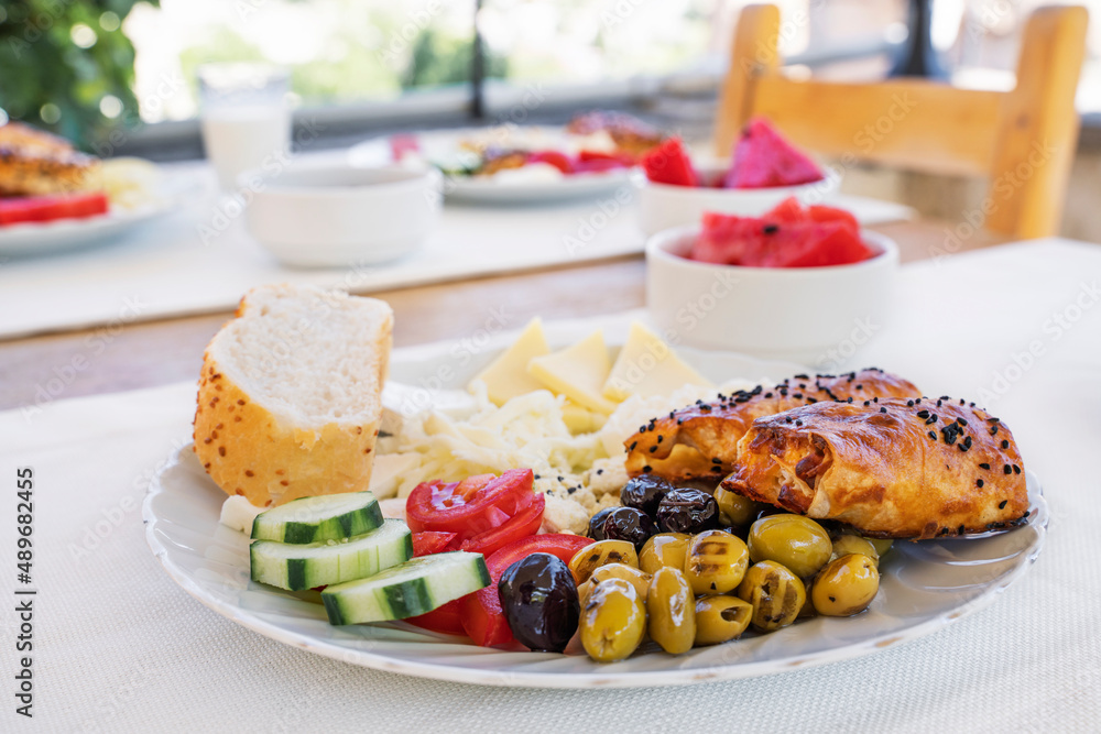 Assorted cheeses and olives, served with vegetables. Traditional Turkish food for breakfast in Goreme. Cappadocia Assorted cheeses and olives, served with vegetables. Traditional Turkish food for breakfast in Goreme. Cappadocia