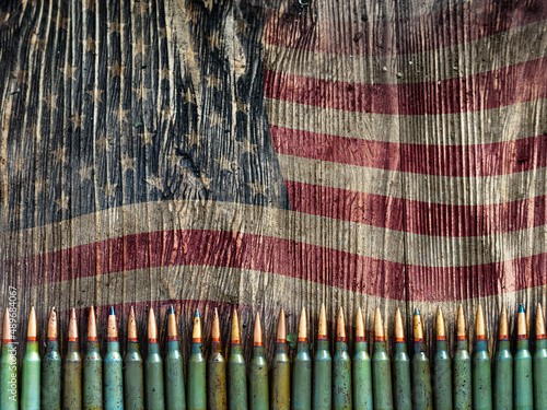 Tela Weapon ammo on an old wooden background with US flag - photo with copy space
