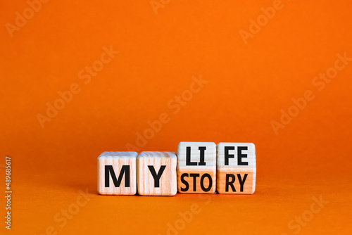 Story of my life symbol. Turned wooden cubes and changed concept words My story to My life. Beautiful orange table orange background. Business story of my life concept. Copy space.