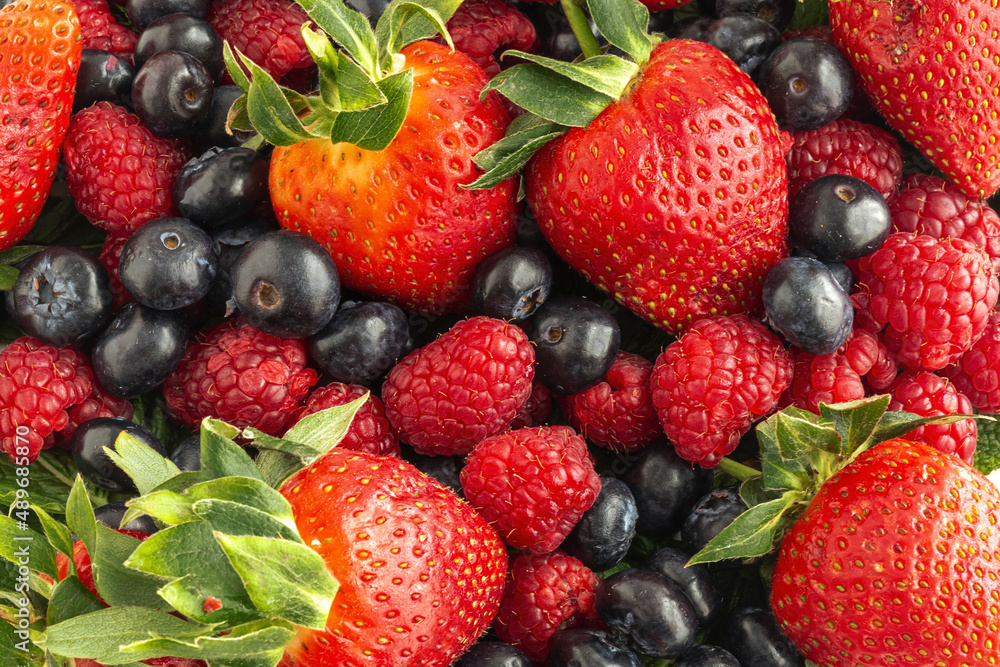 Assortment of red fruits, strawberries, blueberries and raspberries, close up Assortment of red fruits, strawberries, blueberries and raspberries, close up