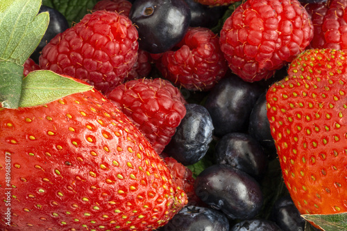 Assortment of red fruits  strawberries  blueberries and raspberries  close up