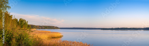 Panoramic view of lake coast on sunrise in spring