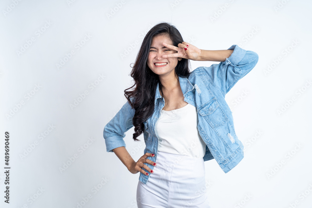Young woman with peaceful hand gesture on isolated background Young woman with peaceful hand gesture on isolated background