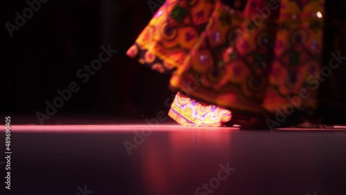 A group of girls dance a cultural dance of India. Close-up of women's feet in Indian outfits. photo