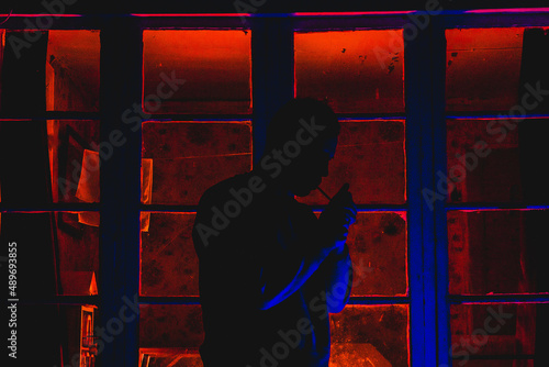  A man on the background of a backlit window, photo at night © Никита Рябкин