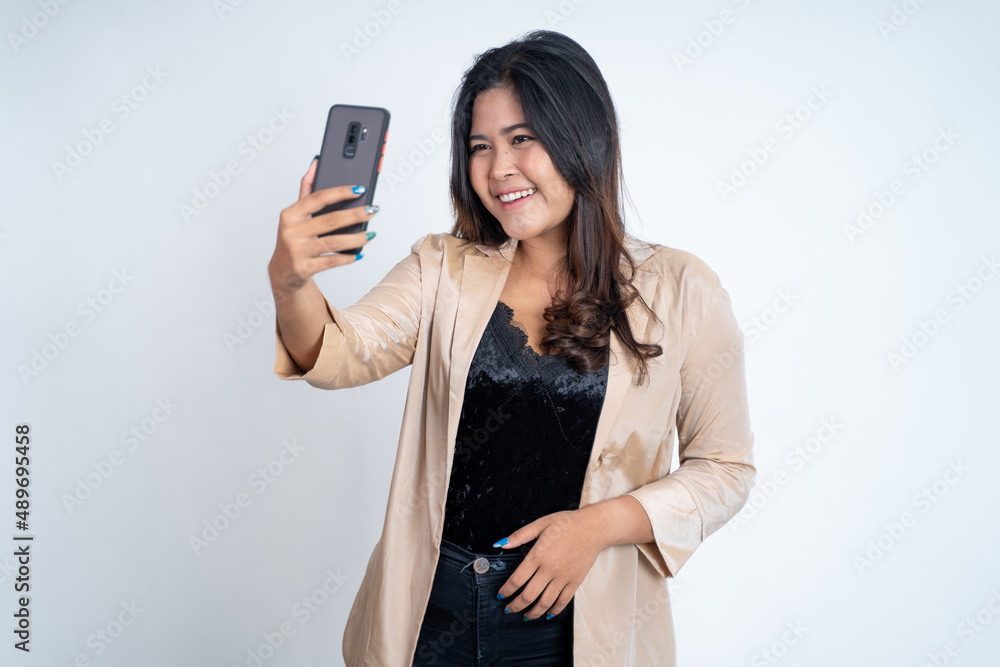 young woman make a video call using mobile phone on isolated background young woman make a video call using mobile phone on isolated background