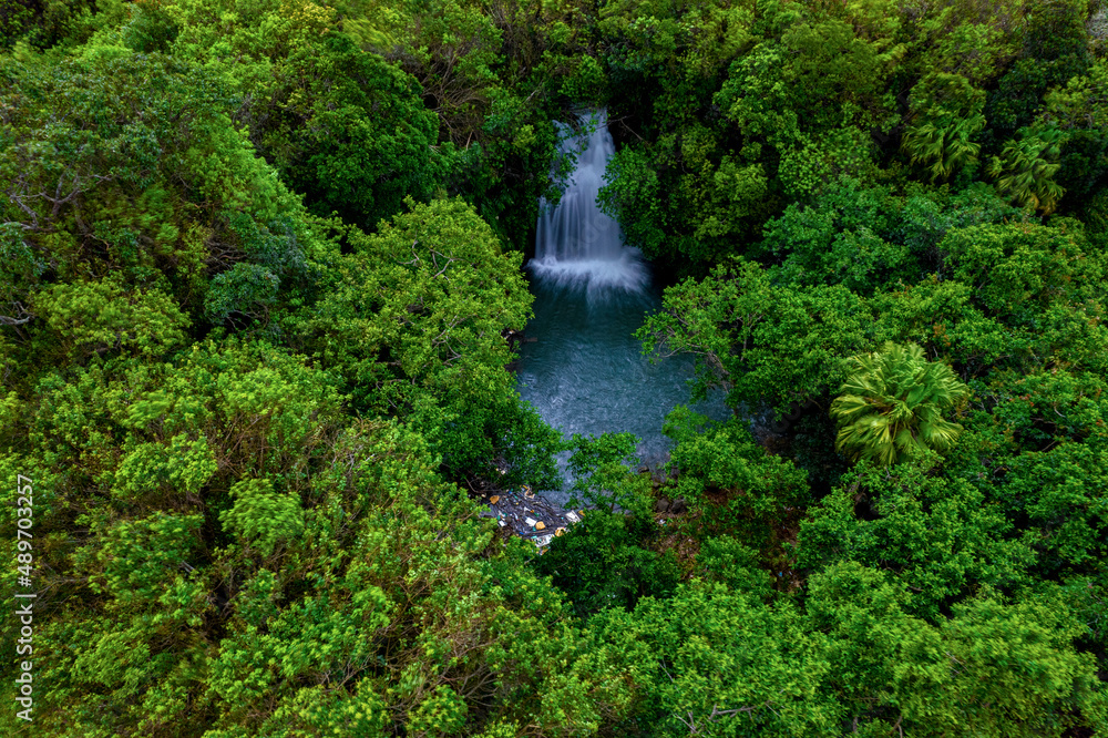 Aerial long exposure view of a hidden waterfall found in a forest located in Mauritius Aerial long exposure view of a hidden waterfall found in a forest located in Mauritius