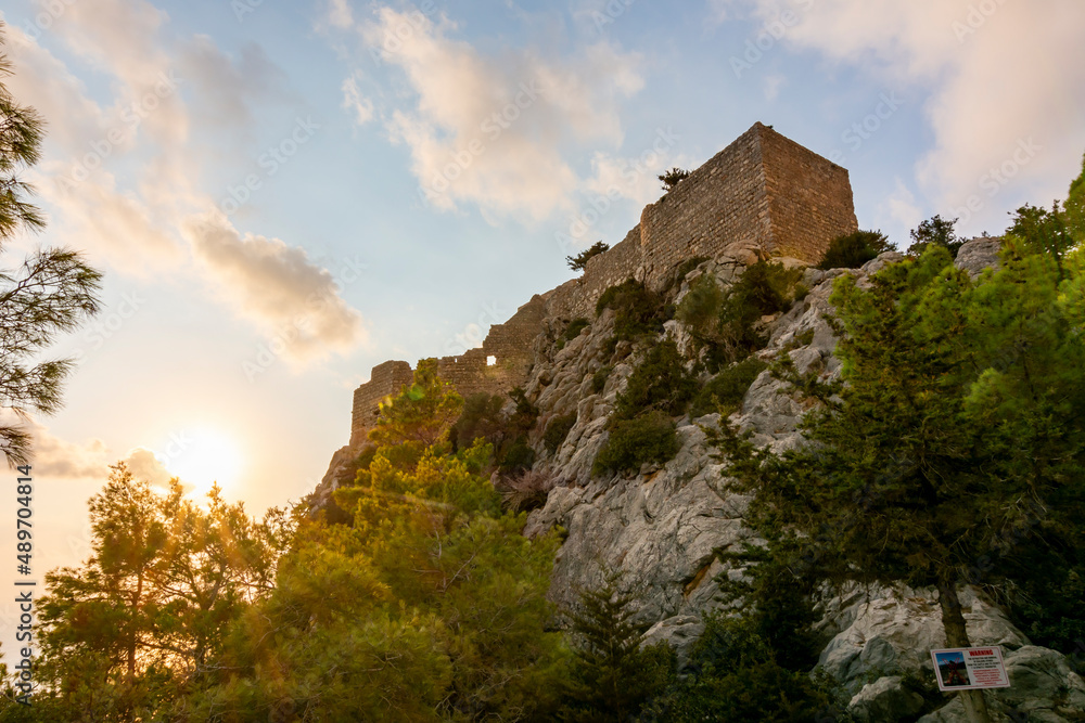 Monolithos castle at sunset on Rhodes island, Greece Monolithos castle at sunset on Rhodes island, Greece