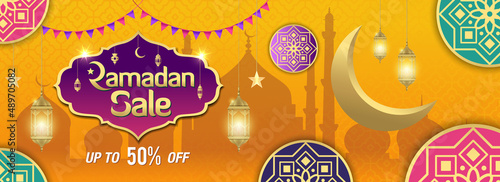 Ramadan Sale, web header or banner design with golden shiny frame, arabic lanterns and golden crescent moon on yellow background.
