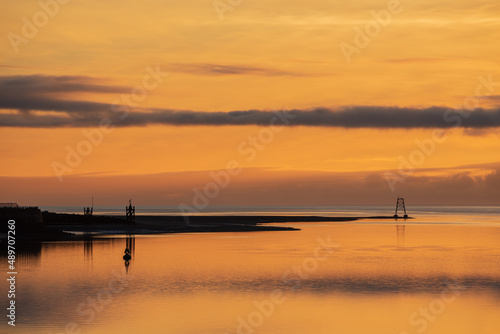 Beautiful sunset landscape image of Solway Firth viewed from Silloth during stunning Autumn sunset with dramatic sky and cloud formations