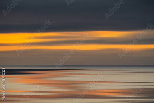 Fototapeta Naklejka Na Ścianę i Meble -  Beautiful sunset landscape image of Solway Firth viewed from Silloth during stunning Autumn sunset with dramatic sky and cloud formations