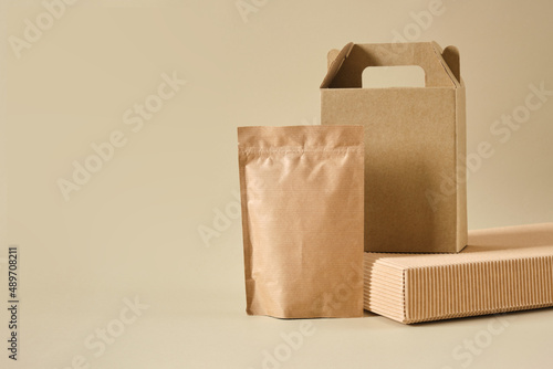 boxes and paper zip bags on a beige background, mock-up packaging for products, packages for delivery