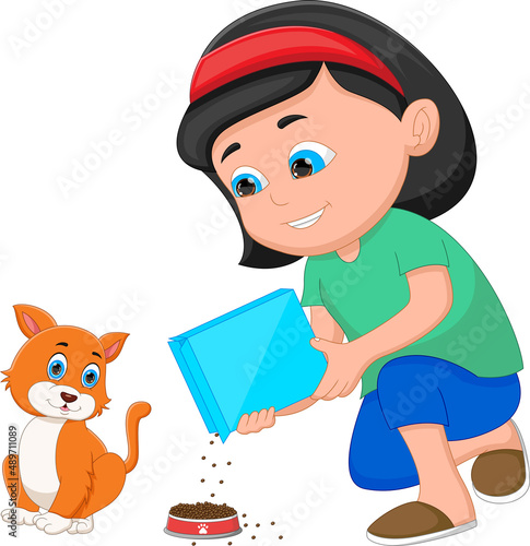 little girl giving food to cat