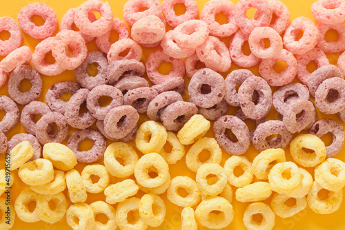 colorful breakfast cereals on yellow background top view