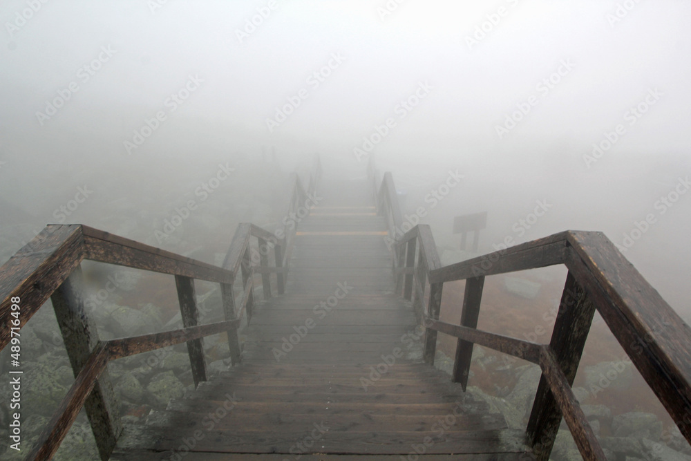 Fototapeta premium Foggy staircase with railing in high mointains
