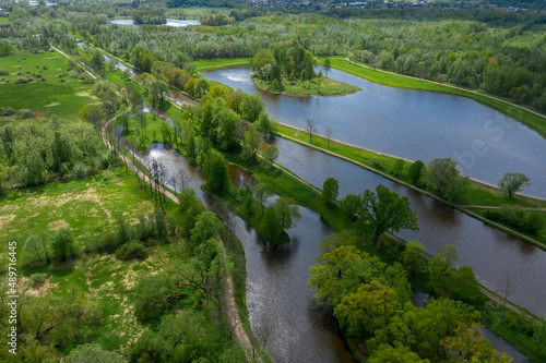 A panoramic view from a height of the ponds and the Landscape Park in Peterhof, the meadow garden, walking paths, the destroyed pavilion.