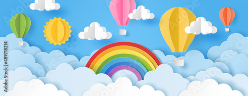 Paper cut style of sun, clouds and hot air balloons with rainbow on blue sky. Summer background. Vector illustration