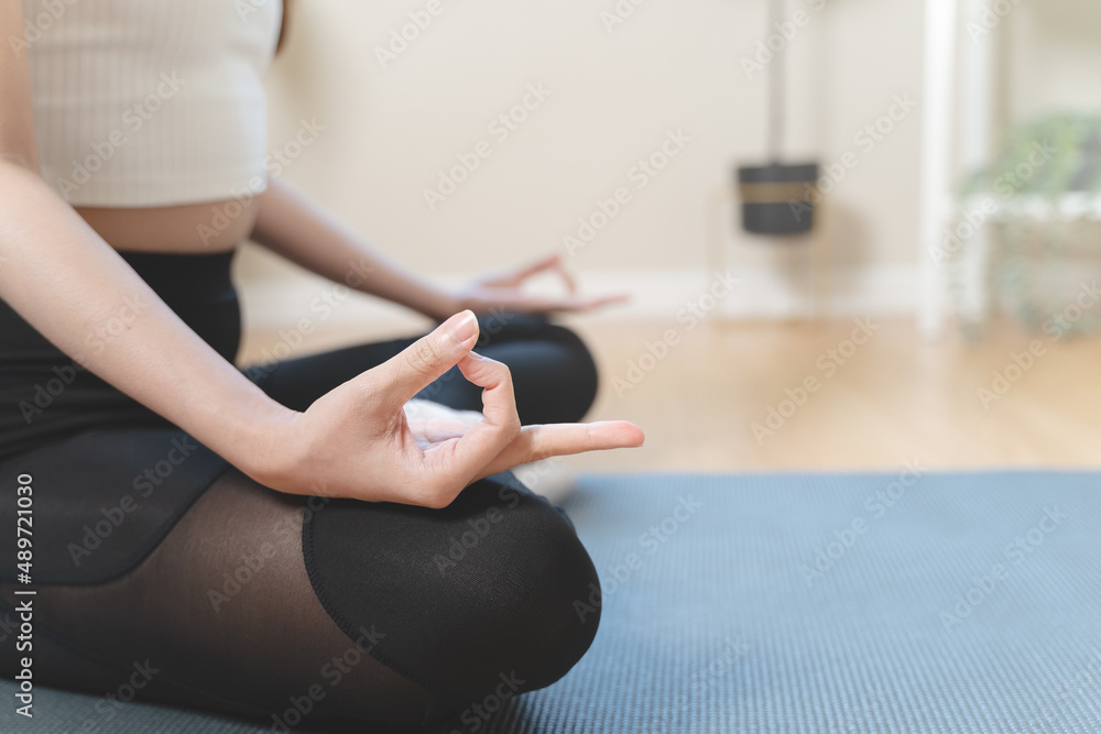 Routine health wellbeing concept. Woman doing meditation at home for practice her mindfulness pose lotus hand and breathing care.