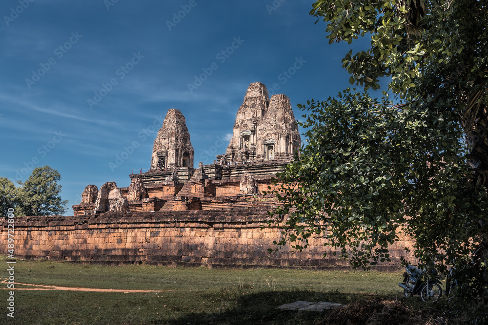 Ruins of ancient Cambodian temple among trees in Angkor complex, Siem Reap, Cambodia Ruins of ancient Cambodian temple among trees in Angkor complex, Siem Reap, Cambodia