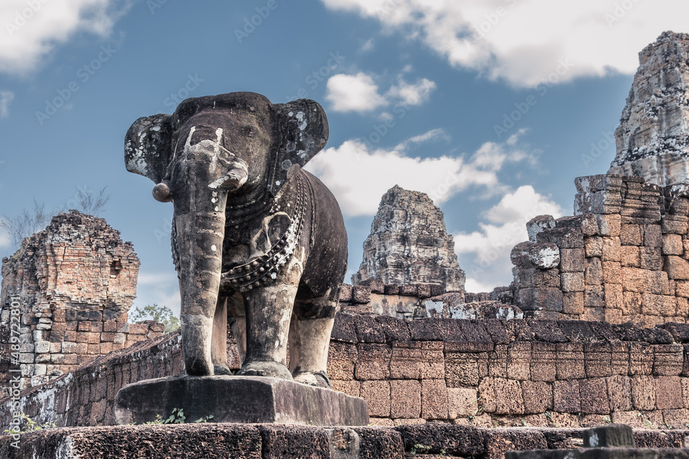 Stone elephant in front of ancient Cambodian temple ruins in Angkor complex, Siem Reap, Cambodia