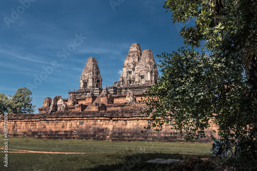 Ruins of ancient Cambodian temple among trees in Angkor complex, Siem Reap, Cambodia