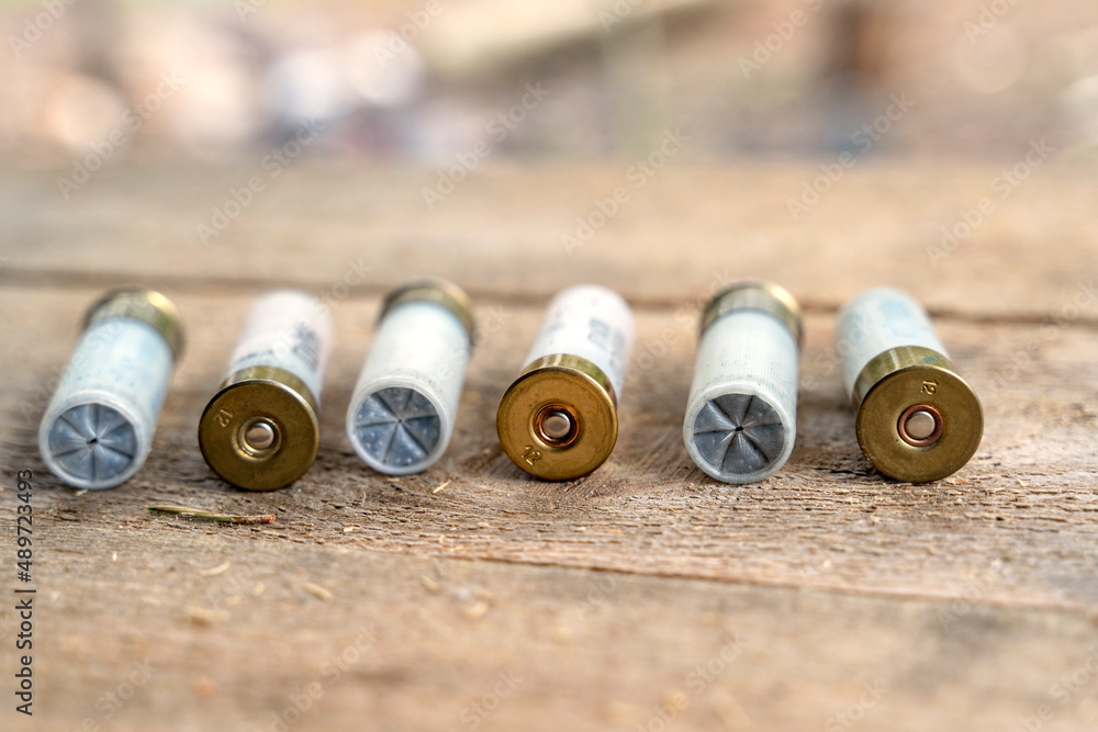 the bullets from the gun on a wooden table the bullets from the gun on a wooden table