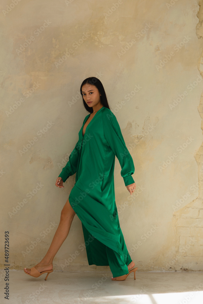 Stylish and fashionable girl with clean skin and Asian appearance in a bright interior