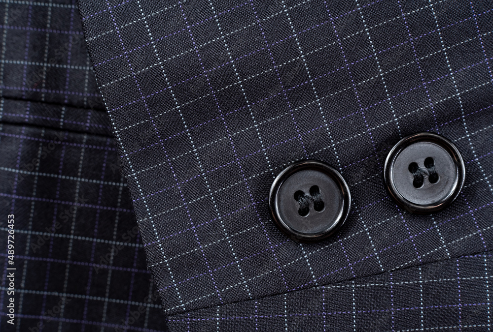 Sleeve with buttons on the men's check suit. Men's suit. Part, item of clothing Sleeve with buttons on the men's check suit. Men's suit. Part, item of clothing