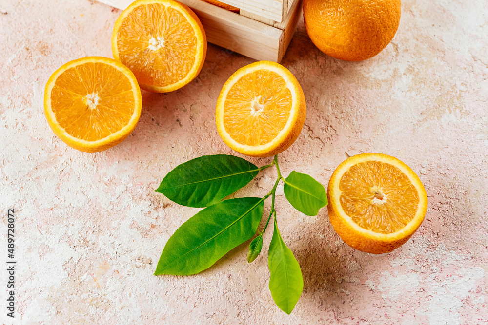 fresh oranges on a light pink background fresh oranges on a light pink background