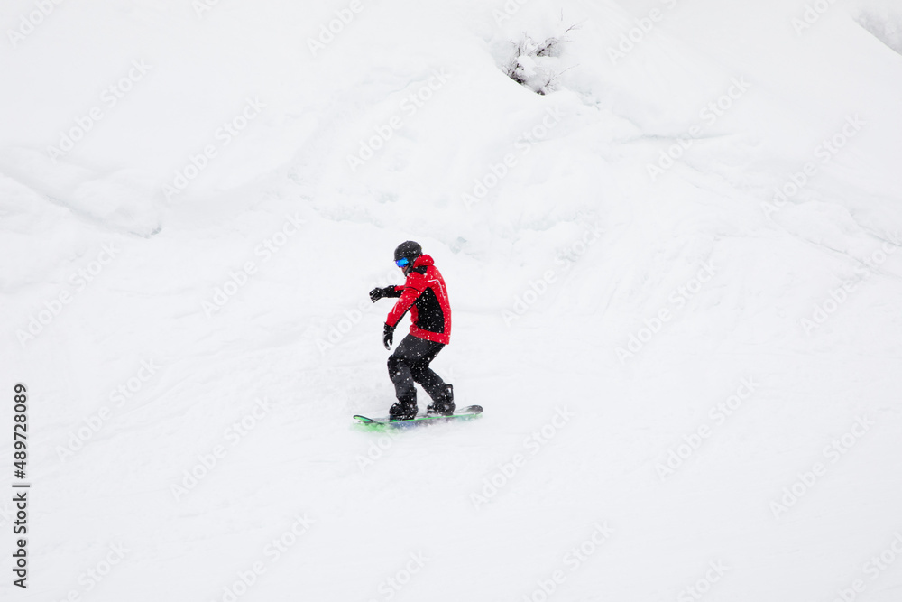 Snowboarder riding fast on snow freeride slope. Snowboarder riding fast on snow freeride slope.