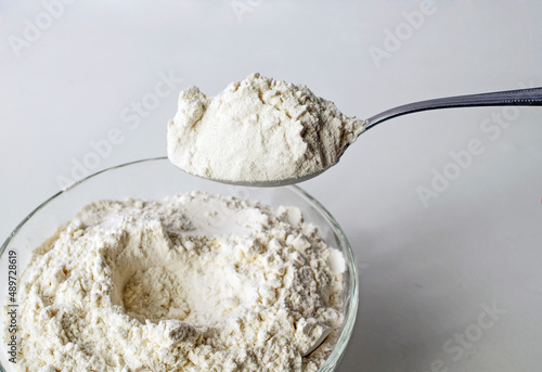 Premium wheat flour, flour in a tablespoon, the process of mixing ingredients for cooking