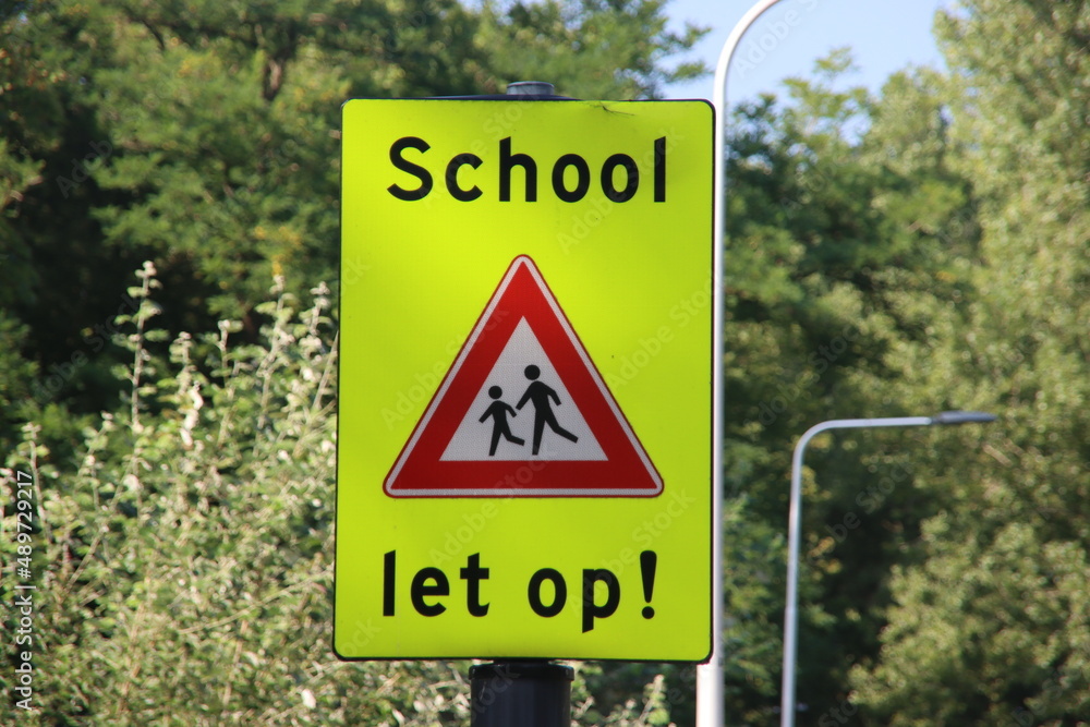 Warning sign in fluorescent yellow for school children