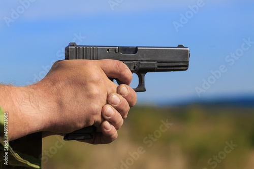 gun held with both hands and ready to fire